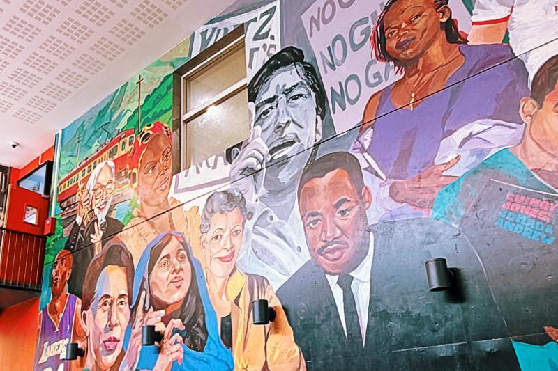 A mural in a cafe depicting a group of political activists