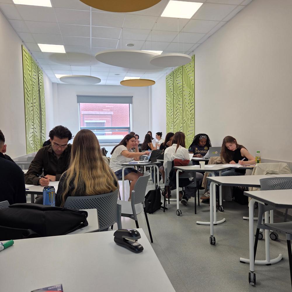 International students work in groups on a project in a classroom